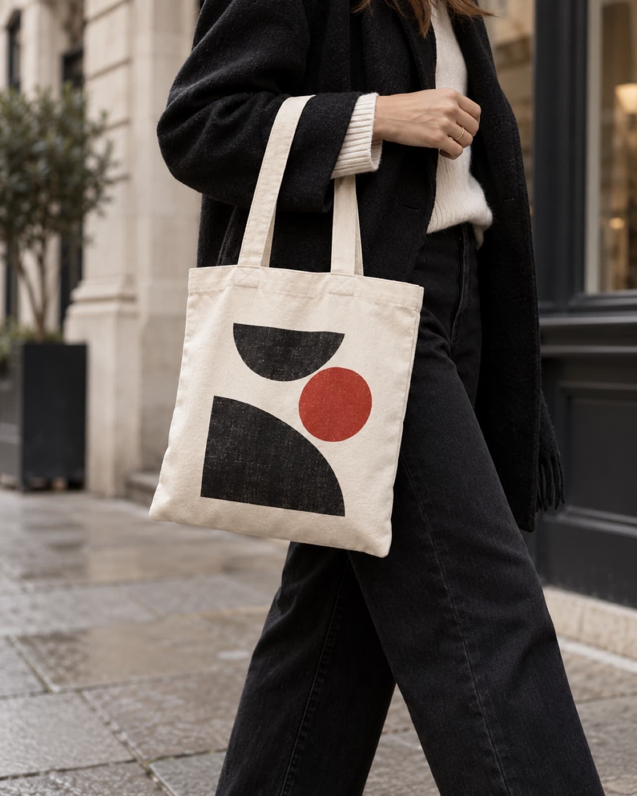 Compact off-white custom printed cotton tote being carried